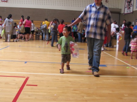 Man with child that is eating cotton candy